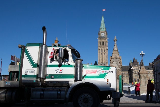 A man waves a Canadian flag during the Convoy for Canada protest in Ottawa on Feb. 19, 2019.