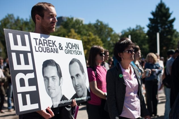 Friends, family and colleagues of Tarek Loubani gather at a rally in Victoria Park in London, Ont. on Sept. 24, 2013, calling on the former Conservative government to become more involved in negotiating the release of Loubani and John Greyson.