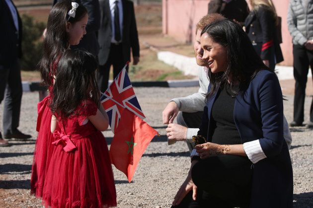 The Duke and Duchess of Sussex meet sisters Rania Minejem, age five and Rayhana Minejem, age two, during a visit to the Education For All boarding house in Asni Town, Morocco.