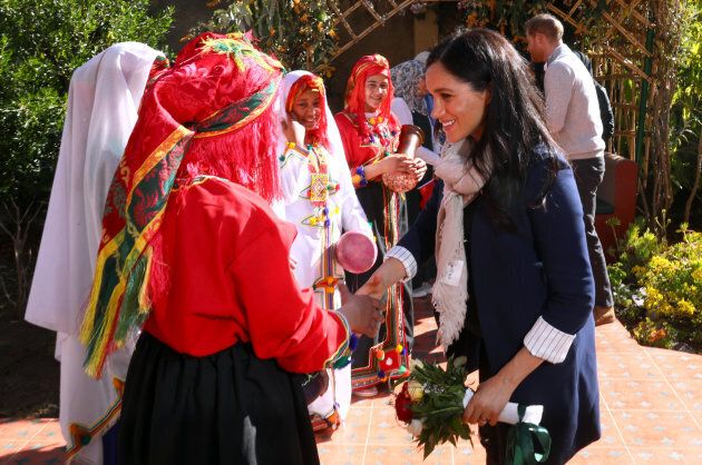 Meghan (and Harry, in the background) with girls age 12 to 18 at the Education for All boarding house.