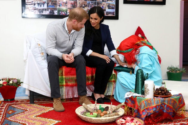 Meghan receives henna during a visit to Education for All.