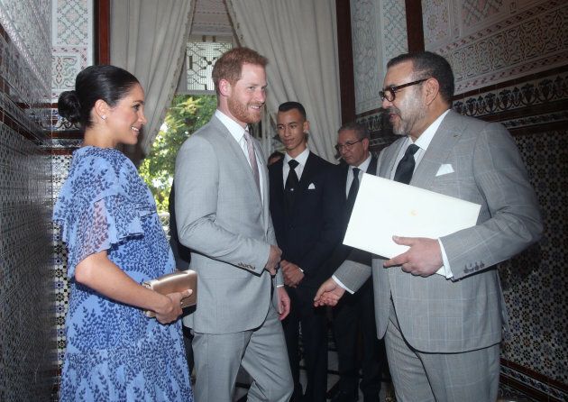 King Mohammed VI of Morocco, right, greets Harry and Meghan.