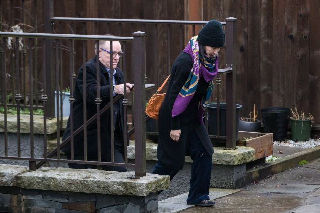 Meng Wanzhou, chief financial officer of Huawei, right, leaves her home.