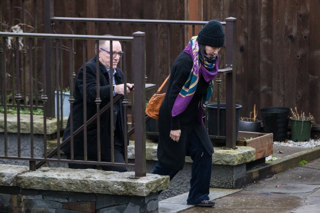 Meng Wanzhou, chief financial officer of Huawei, right, leaves her home.