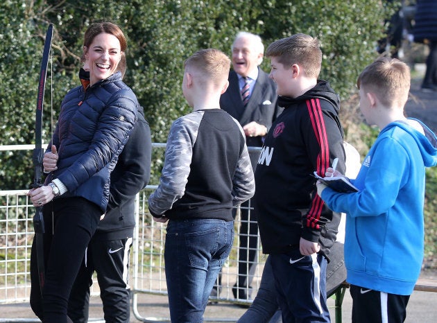 Kate Middleton enjoys a moment with some kids as she tries some archery at Roscor Youth Village in Fermanagh, Northern Ireland.