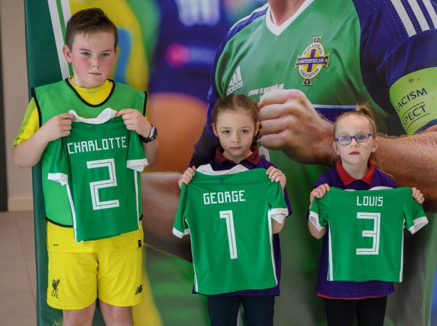 Catherine, Duchess of Cambridge and Prince William, Duke of Cambridge are given football shirts for their children during a visit the National Stadium in Belfast. Look how tiny Louis's is!