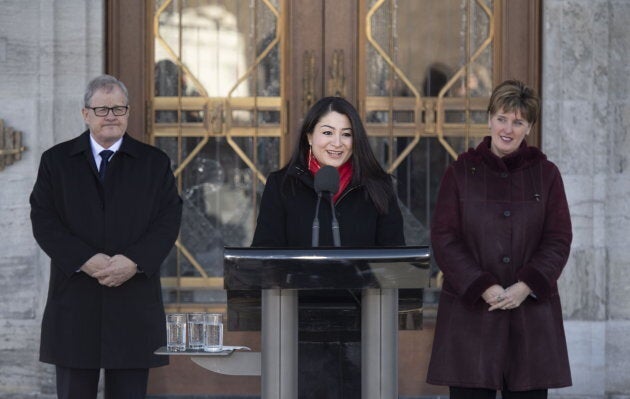 Minister for Women and Gender Equality and Minister of International Development Maryam Monsef speaks to reporters as Minister of Veterans Affairs and Associate Minister of National Defence Lawrence MacAulay, left, and Minister of Agriculture and Agri-Food Marie-Claude Bibeau listen, following a cabinet shuffle at Rideau Hall in Ottawa on March 1, 2019.