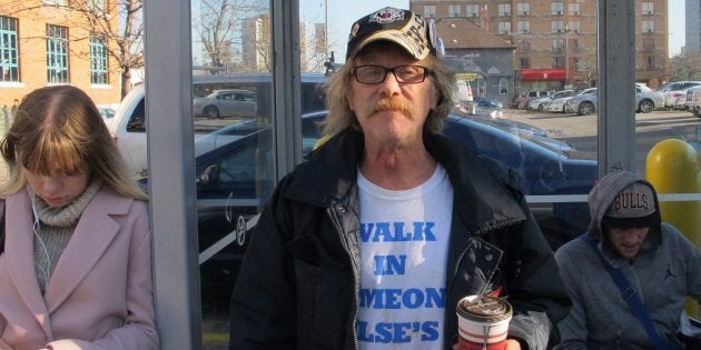 Tim Button poses for a photo while waiting for the bus in Hamilton, Ont. on Nov. 21, 2017. Bus rides are one of the luxuries Button could not afford before enrolling in Ontario's basic income pilot project.