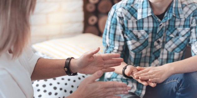 Gesturing while talking. Scaled up shot of a therapeutic process between a professional therapist and a teenage boy in an office.