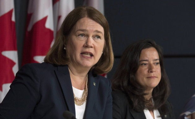 Jane Philpott responds to a question Jody Wilson-Raybould looks on during a news conference in Ottawa on June 30, 2016.