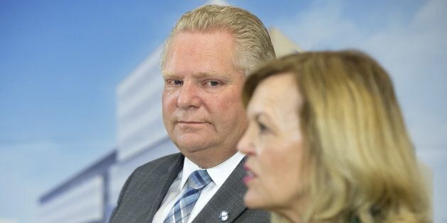 Ontario Premier Doug Ford watches as Health Minister Christine Elliott speaks at an event at the Centre for Addiction and Mental Health in Toronto on Jan. 30, 2019.