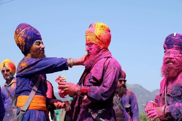 Nihang Sikhs seen playing Holi during the annual fair of Hola Mohalla in Punjab, India.