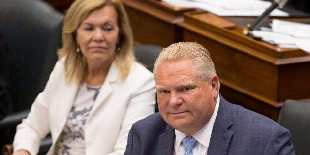 Ontario Premier Doug Ford, right, sits next to Health Minister Christine Elliott during Question Period at Queen's Park, in Toronto on July 31, 2018.