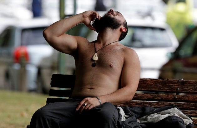 A man reacts as he speaks on a mobile phone outside a mosque in central Christchurch, New Zealand on Friday.