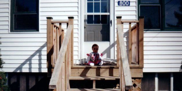 Author Haley Lewis sitting on the porch of her family home in Taymouth, N.B.