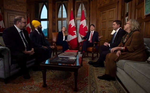 Bloc interim leader Mario Beaulieu (left), NDP leader Jagmeet Singh, Tourism Minister Melanie Joly, Conservative Leader Andrew Scheer and Green Party leader Elizabeth May listen as Prime Minister Justin Trudeau delivers opening remarks on francophone issues in his Ottawa office on Nov. 28, 2018.