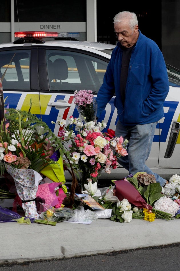 A men places flowers at a makeshift memorial near the Masjid Al Noor mosque in Christchurch, New Zealand.