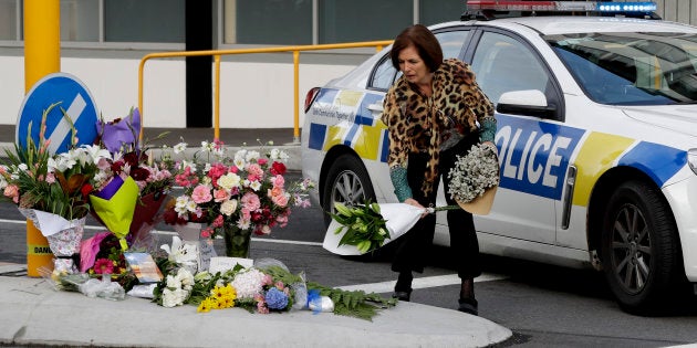 A woman places flowers at a make-shift memorial near the mosque in Christchurch, New Zealand on Saturday.