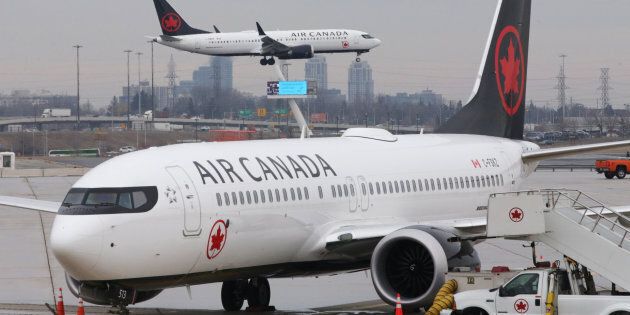 An Air Canada Boeing 737 MAX 8 from San Francisco approaches for landing at Toronto Pearson International Airport over a parked Air Canada Boeing 737 MAX 8 aircraft in Toronto on March 13, 2019.