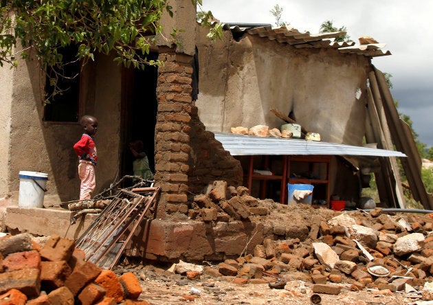 A boy looks on at a family home destroyed by floods following Cyclone Idai in Chimanimani district, Zimbabwe, on March 18, 2019.