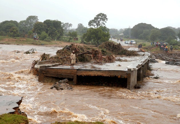 A man looks at a washed away bridge along Umvumvu river following Cyclone Idai in Chimanimani, Zimbabwe on March 18, 2019.