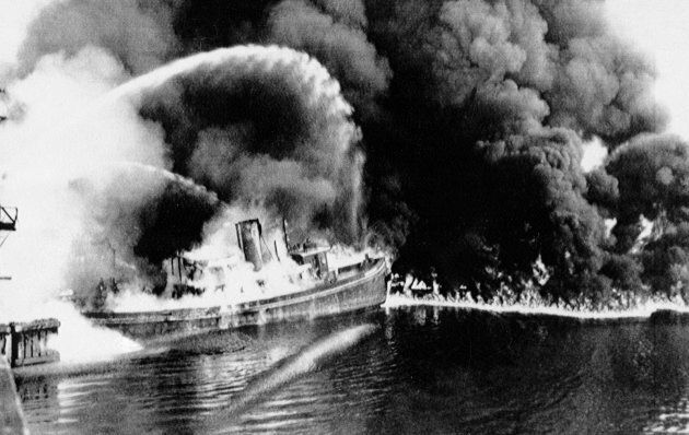In this June 25, 1952 file photo, a fire tug fights flames on the Cuyahoga River near downtown Cleveland, OH, where oil and other industrial wastes caught fire.