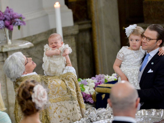 Arch Bishop Antje Jackela holds Prince Oscar - who is NOT A FAN OF WATER, THANKYOUVERYMUCH - while Princess Estelle and Prince Daniel look on at the christening on May 27, 2016 at the Chapel in Stockholm's Royal palace.