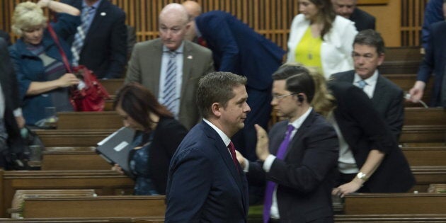 Conservative leader Andrew Scheer leads members of his party out of the House of Commons during the delivery of the federal budget in the House of Commons on March 19, 2019 in Ottawa.