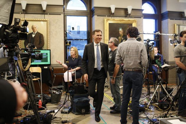 Bill Morneau smiles as he departs a television interview after tabling the federal budget in Ottawa on March 19, 2019.