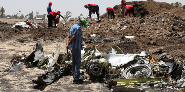 A man watches debris at the scene of the Ethiopian Airlines Flight ET 302 plane crash, near the town of Bishoftu, southeast of Addis Ababa, Ethiopia on March 12, 2019.