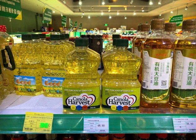 Bottles of Canadian-manufactured canola oil, centre, seen on a shelf of a grocery store in Beijing.