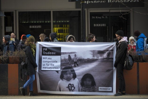 Protestors hold a sign outside the Liberal party Laurier Club event in Toronto on March 27, 2019.