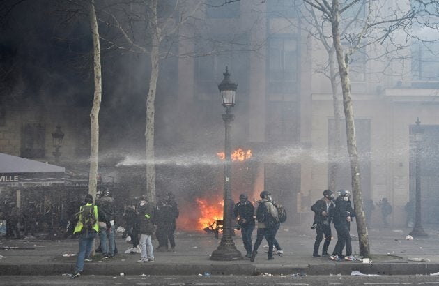 French riot police use water cannon to disperse yellow-vest protesters on the Champs-Elysees during the 18th consecutive Saturday national protest in Paris, France on March 16, 2019.