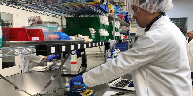 Impossible Foods product development associate scientist Kyle Okada measures plant-based burgers tailor-made for Burger King at a facility in Redwood City, Calif., March 26, 2019.