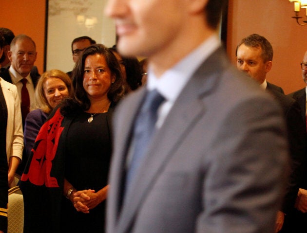 Jody Wilson-Raybould watches Prime Minister Justin Trudeau arrive at Rideau Hall for a cabinet swearing-in ceremony in Ottawa on Jan. 14, 2019.