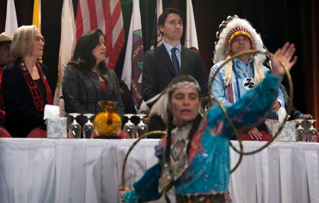 A hoop dancer performs as then-Indigenous Affairs minister Carolyn Bennett, Jody Wilson-Raybould, Prime Minister Justin Trudeau and AFN National Chief Perry Bellegarde take their places on stage at the Assembly of First Nations Special Chiefs Assembly in Gatineau, on Dec. 8, 2015.