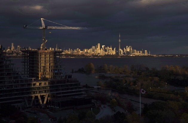 Condominiums are seen under construction in front of the skyline in Toronto on Oct. 31, 2017.