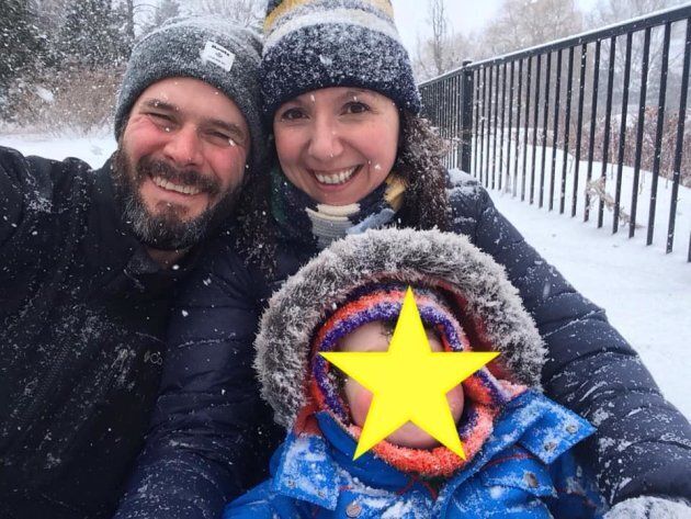 Natalie Stechyson and her husband enjoying a sled ride with their son. This was taken in Ottawa, so it's probably April.