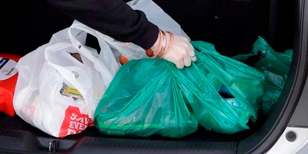 A shopper places her goods into her car outside a supermarket in Christchurch, New Zealand, on Aug. 10, 2018.