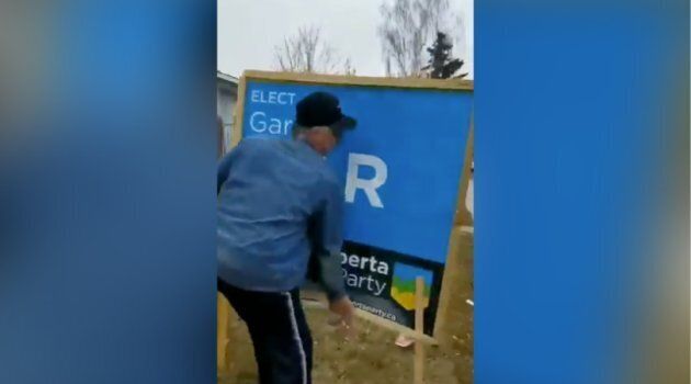 A screengrab from a video that Alberta Party candidate Gar Gar shared on Twitter shows a man forcibly removing one of his campaign signs.