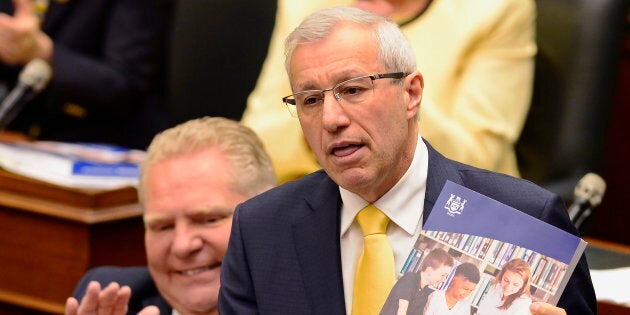 Ontario Finance Minister Vic Fedeli presents the 2019 budget as Premier Doug Ford looks on at the legislature in Toronto on April 11, 2019.