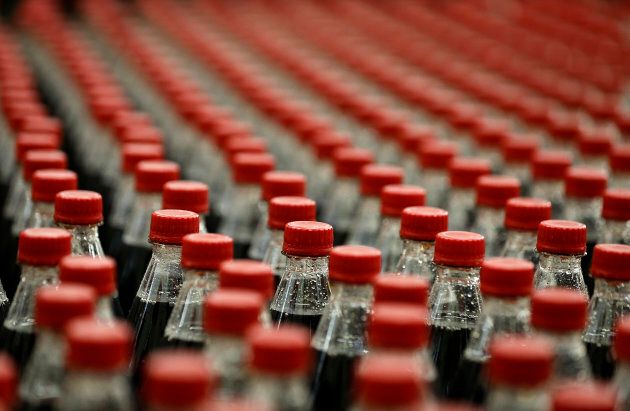Soft drinks move down a production line at a Coca-Cola bottling plant.
