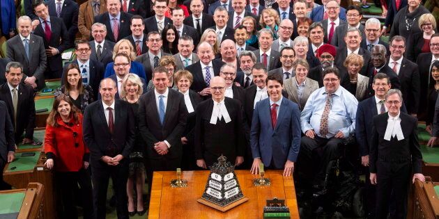 The Speaker of the House of Commons Geoff Regan, Conservative Leader Andrew Scheer and Prime Minister Justin Trudeau stand with MPs as they pose for a photo before question period on Dec. 12, 2018 in Ottawa.