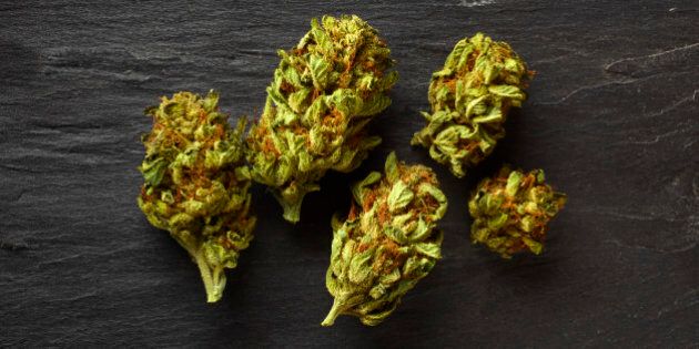 Medical marijuana flowers from a California dispensary on a slate tabletop.
