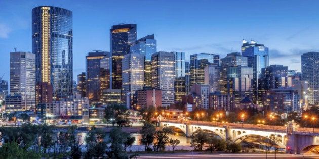 Calgary skyline at night with Bow River and Centre Street Bridge.