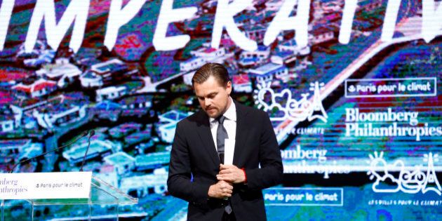 Leonardo DiCaprio walks out after his speech to the audience during a meeting with Mayors to push for local actions to fight climate change at Paris city Hall on the margins of the COP21, as part of the COP21, United Nations Climate Change Conference, in Paris, Friday, Dec. 4, 2015. (AP Photo/Francois Mori)
