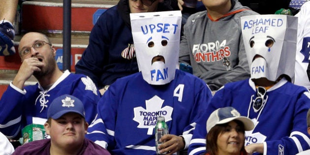 Toronto Maple Leafs fans wear bags over their heads in the third period of an NHL hockey game against the Florida Panthers, Thursday, April 10, 2014, in Sunrise, Fla. The Panthers defeated the Maple Leafs 4-2. (AP Photo/Lynne Sladky)