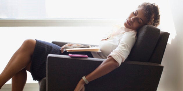 Businesswoman sleeping in office chair