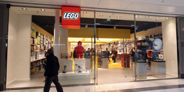 A man passes by the newly-opened store of Danish construction toys group Lego on October 18, 2012 at the 'So Ouest' shopping center in Levallois-Perret, west of Paris. AFP PHOTO/THOMAS SAMSON (Photo credit should read THOMAS SAMSON/AFP/Getty Images)