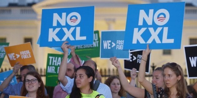 Activists, celebrating US President Barack Obama's blocking of the Keystone XL oil pipeline, rally in front of the White House in Washington, DC on November 6, 2015. US President Barack Obama blocked the Keystone XL oil pipeline that Canada sought to build into the United States, ruling it would harm the fight against climate change. AFP PHOTO/MANDEL NGAN (Photo credit should read MANDEL NGAN/AFP/Getty Images)